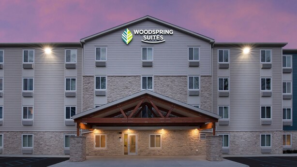 A multi-story hotel with a stone facade and a prominent entrance.