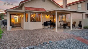 A house with a covered patio, a barbecue area, and a view of the surrounding landscape. - Upscale Private Home In A Quite Gated Community With Breathtaking Mountain Views (Tucson)