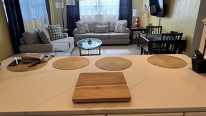 A modern living room with a sofa, coffee table, and TV.