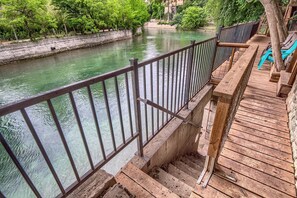 A wooden deck with a metal railing overlooking a river. - Star Haus DT 292 5 Bedroom Home by RedAwning (New Braunfels)