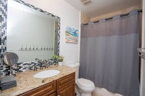 A bathroom with a sink, mirror, and toilet. - Fort Lauderdale Beach, LAS OLAS, Big Heated Pool & 7 person hot tub (Fort Lauderdale)