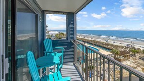A balcony with turquoise chairs, a pool, and a beach view. - Direct OCEANFRONT Remodeled 4th Floor End Unit Myrtle Beach Resort (Myrtle Beach)