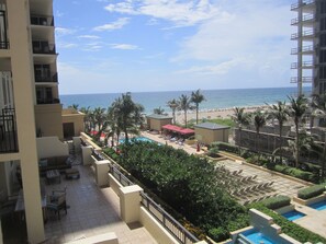 A resort with a pool, lounge chairs, and a view of the beach and ocean. - Singer Island Resort & Spa Private Owner (Singer Island)