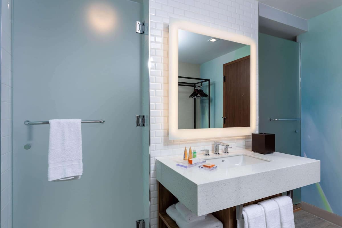 rainfall showerhead, designer toiletries, hair dryer, towels