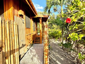 A wooden building with a covered walkway leading to a door.