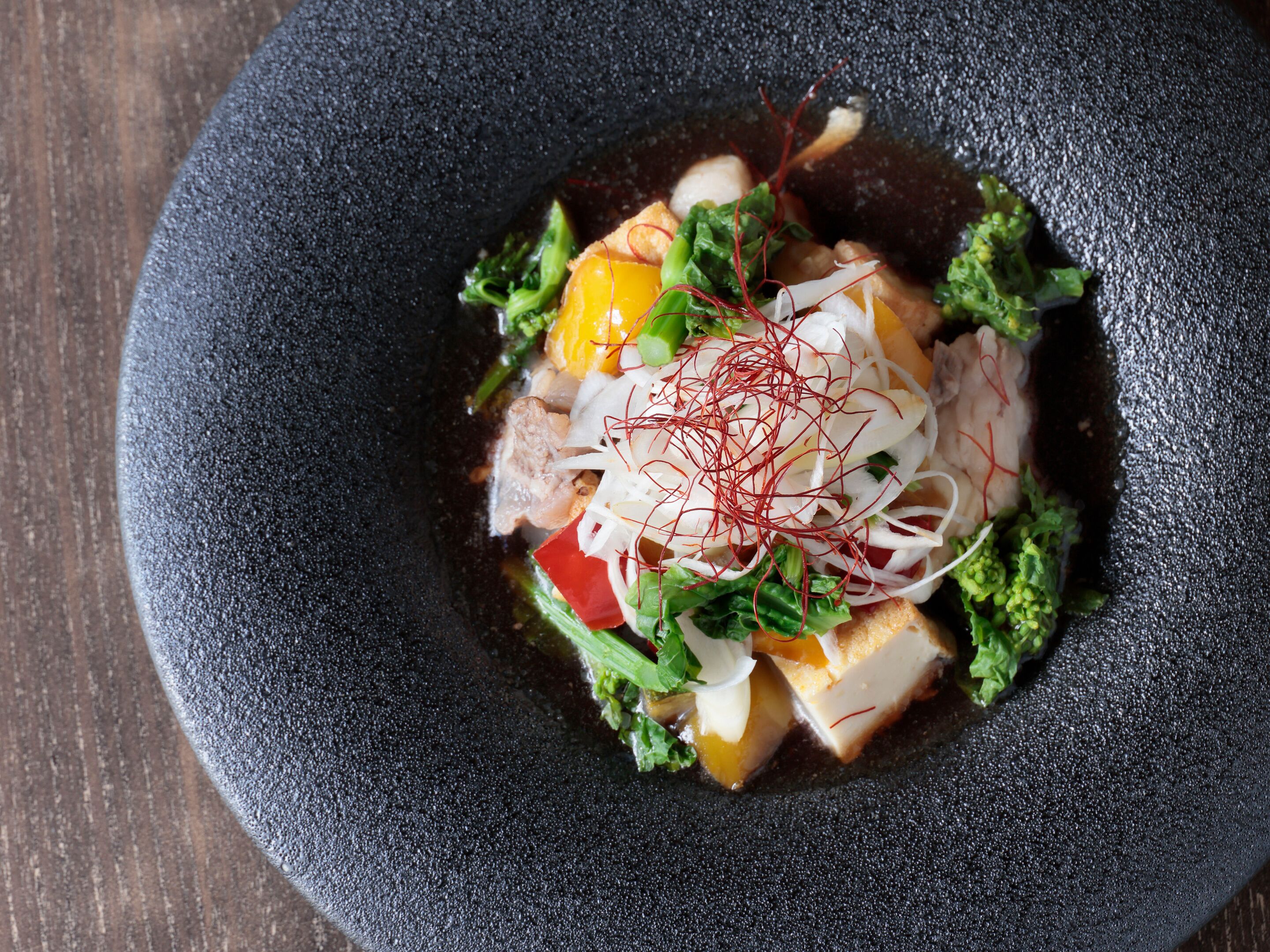 A bowl of food with various ingredients.