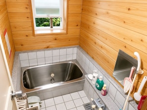 A compact wooden bathroom with a built-in stainless steel sink, a window, and a tiled floor. - Pension Poka Poka (Katashina)