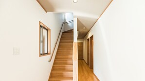 A staircase with wooden steps leading to an upper floor. - Tabist Miya Yokkaichi Suizawa (Yokkaichi)