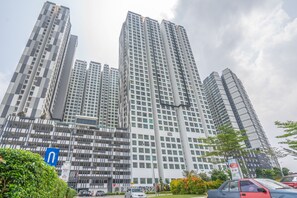A high-rise building with multiple floors, large windows, and a modern architectural design.