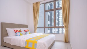 A bedroom with a bed, curtains, and a window with a city view. - OYO Home 89458 Amazing 2br D'summit (Johor Bahru)