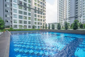 A swimming pool surrounded by high-rise residential buildings.