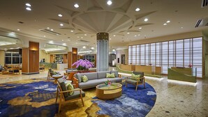 A spacious lobby with a reception desk, seating area, and a bar. - ANA Crowne Plaza Resort Okinawa Uruma Hills by IHG (Uruma)