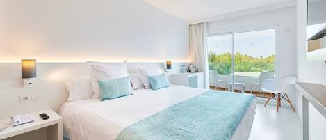 A modern hotel room with a large bed, bedside tables, a desk, and a balcony with a view.