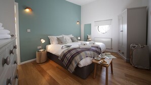 A neatly arranged bedroom with a bed, bedside table, and a wardrobe. - A yorkshire dale that sleeps 6 guests  in 3 bedrooms (Richmond)