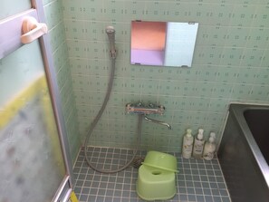 Une salle de bain avec une douche, des toilettes et un lavabo.