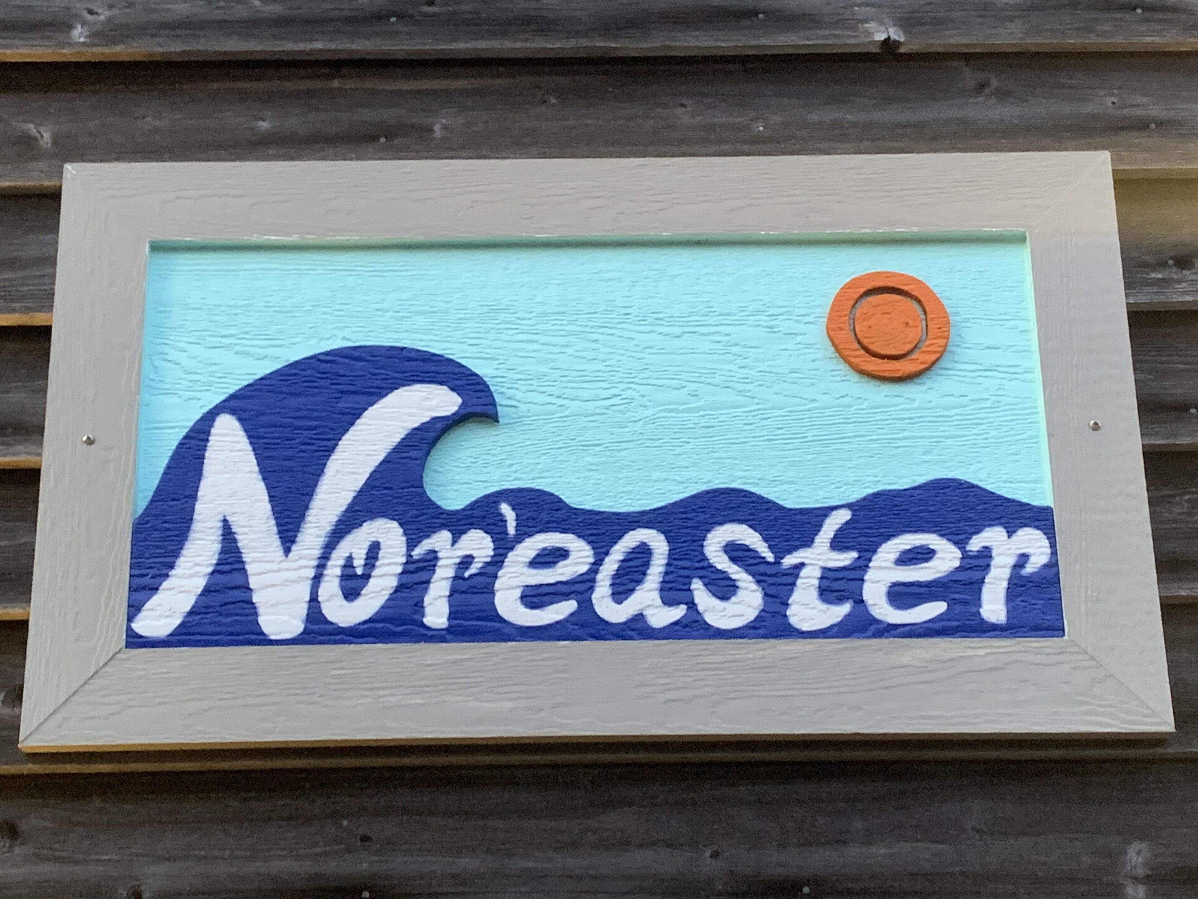 A framed artwork with the word "Noreaster" and a stylized wave design.