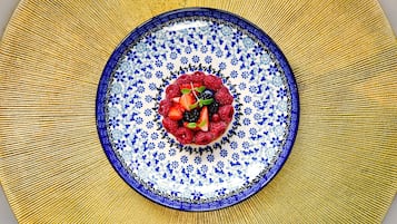 A plate with a blue floral pattern and a central berry mixture.