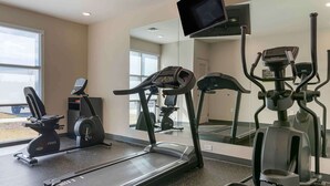 A gym with cardio equipment including treadmills and an elliptical, large windows, and a TV mounted on the wall. - Extended Stay America Premier Suites Savannah Pooler (Pooler)