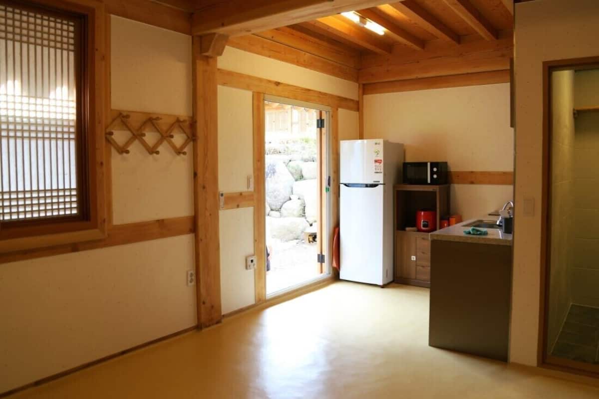 Une petite cuisine équipée d’un réfrigérateur, d’un four à micro-ondes et d’un évier.
