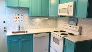 Effortlessly cook up a meal in this kitchen with a dishwasher, stove, and microwave.