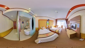 A hotel room with two beds, a bathroom, a desk, and a television. - Hoa Dao Hotel (Hoa Binh)