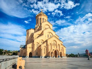 A large, historic church with a prominent bell tower and multiple arches. - BARNOVI BOUTIQUE HOTEL (Tbilisi)