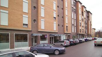 A multi-story building with a cafe and hotel on the ground floor.