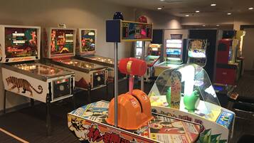 A row of arcade games with a variety of colorful designs and Japanese text.
