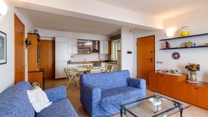 A compact living space with a kitchenette, a sofa, a coffee table, and a dining area. - Fontana Vecchia Seaview Apartment  (Taormina)