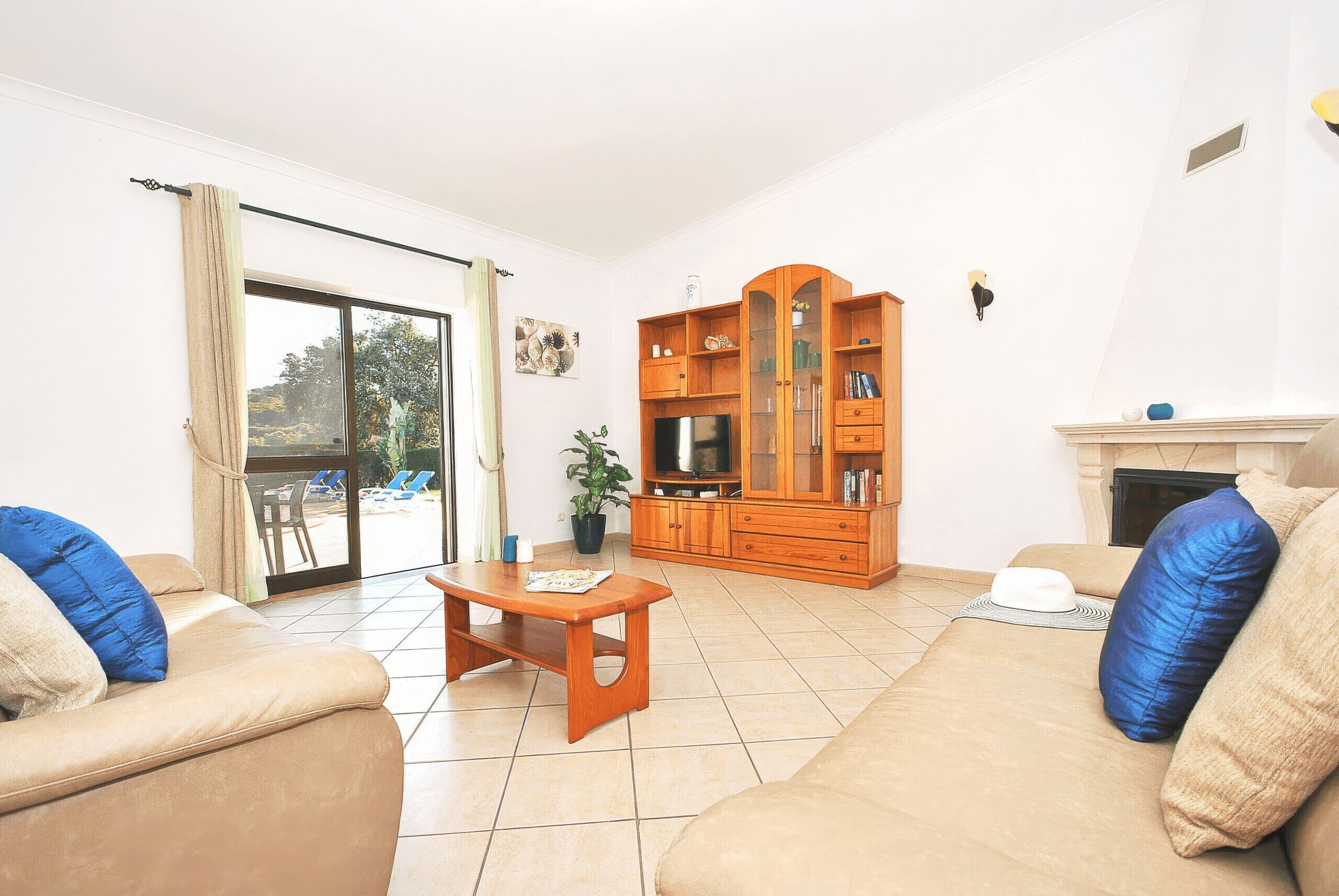 A living room with a sofa, a coffee table, and a TV stand.