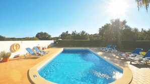 A rectangular swimming pool with clear blue water, surrounded by lounge chairs and potted plants. - Quiet retreat with pool and BBQ (Albufeira)