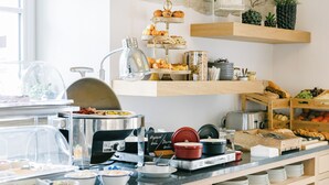 A buffet setup with various food items and a coffee station. - Na Kmíně (Obríství)