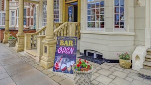 A hotel entrance with a sign reading "EMPIRE HOTEL" and a "BAR OPEN" sign. - Empire Hotel (Leicester)