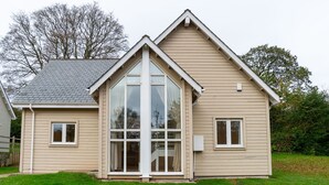A two-story house with a gable roof, large windows, and a front porch. - Trewhiddle Villa 1 -  a trewhiddle that sleeps 7 guests  in 4 bedrooms (Saint Austell)
