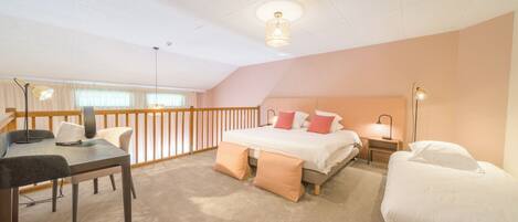 A bedroom with a bed, bedside tables, a desk, and a chair.