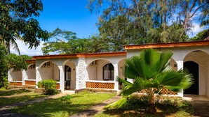 A colonial-style building with arched doorways and a tiled roof. - Diani Sea Lodge (Diani Beach)