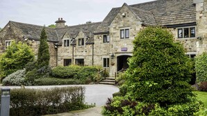 A stone building with a reception area, surrounded by well-maintained gardens and a clear pathway. - Mercure Barnsley Tankersley (Barnsley)
