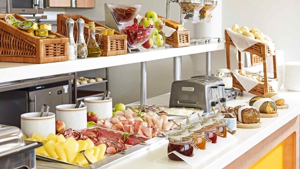Una mesa de buffet con diferentes alimentos y salsas.
