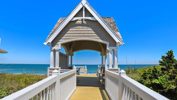 A wooden pier leading to a beach with a gazebo structure at the end. - AMAZING HOME in Four Seasons in Duck! Private Pool! 10% OFF available summer weeks! (Duck)