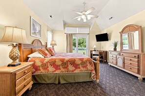 A bedroom with a bed, dresser, desk, and ceiling fan. - AMAZING HOME in Four Seasons in Duck! Private Pool! 10% OFF available summer weeks! (Duck)