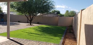 Backyard has artifical turf and is beautiful area to relax