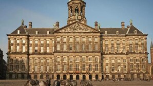 A large, historic building with a prominent clock tower and classical architecture. - Dase Bed & Breakfast (Amsterdam)