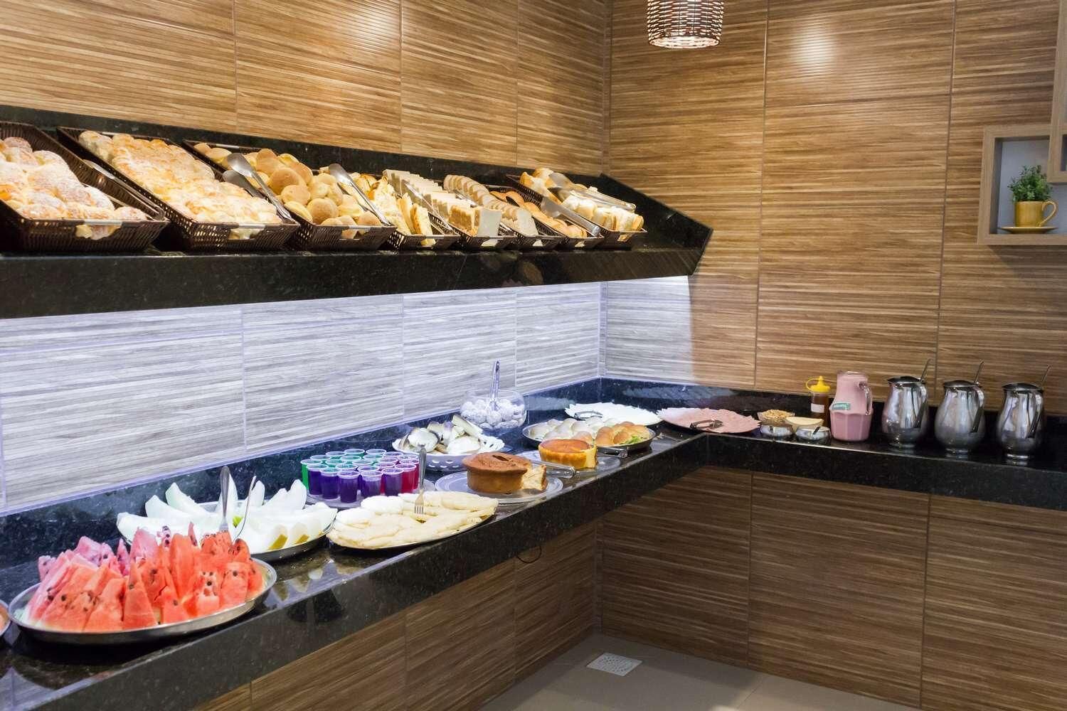 A buffet with various food items and beverages.