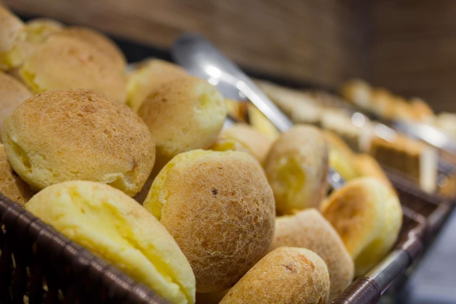 A basket of round, golden-brown bread rolls.