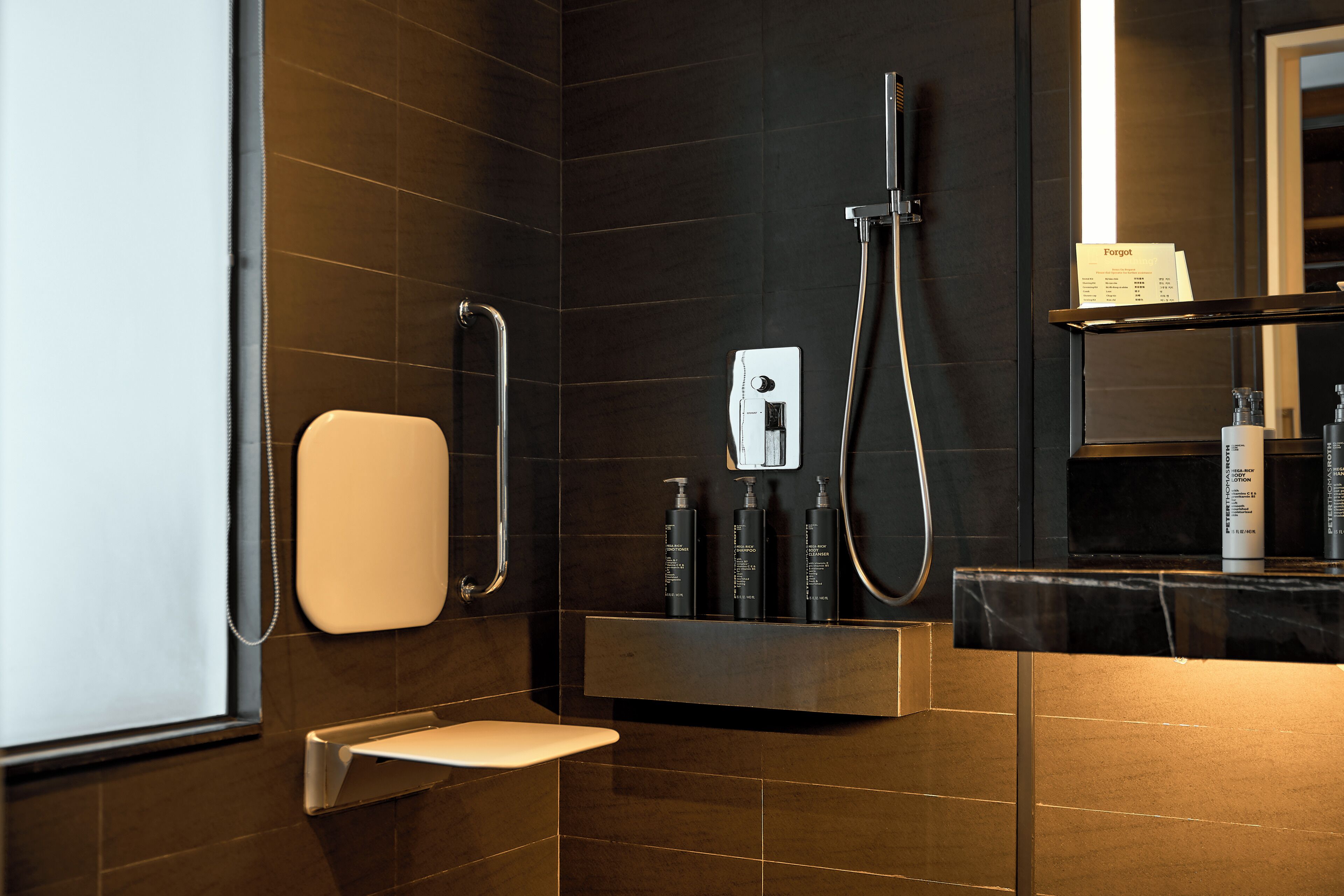 A modern bathroom with a shower, toilet, and vanity.