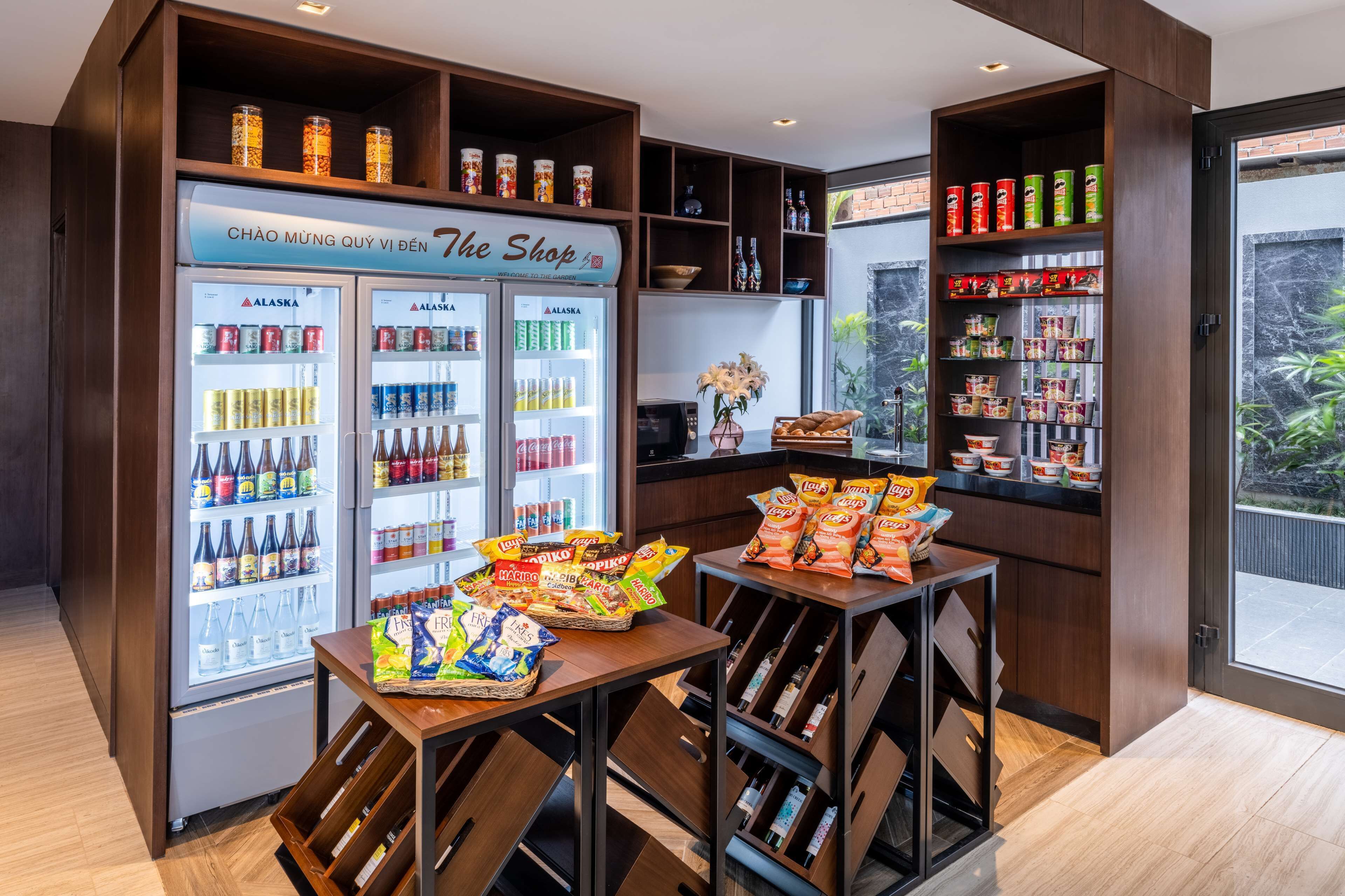 A snack bar with a variety of snacks and beverages, including a refrigerated display with drinks and snacks.