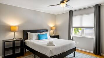 Premium bedding, desk, laptop workspace, blackout drapes