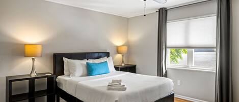 Premium bedding, desk, laptop workspace, blackout curtains