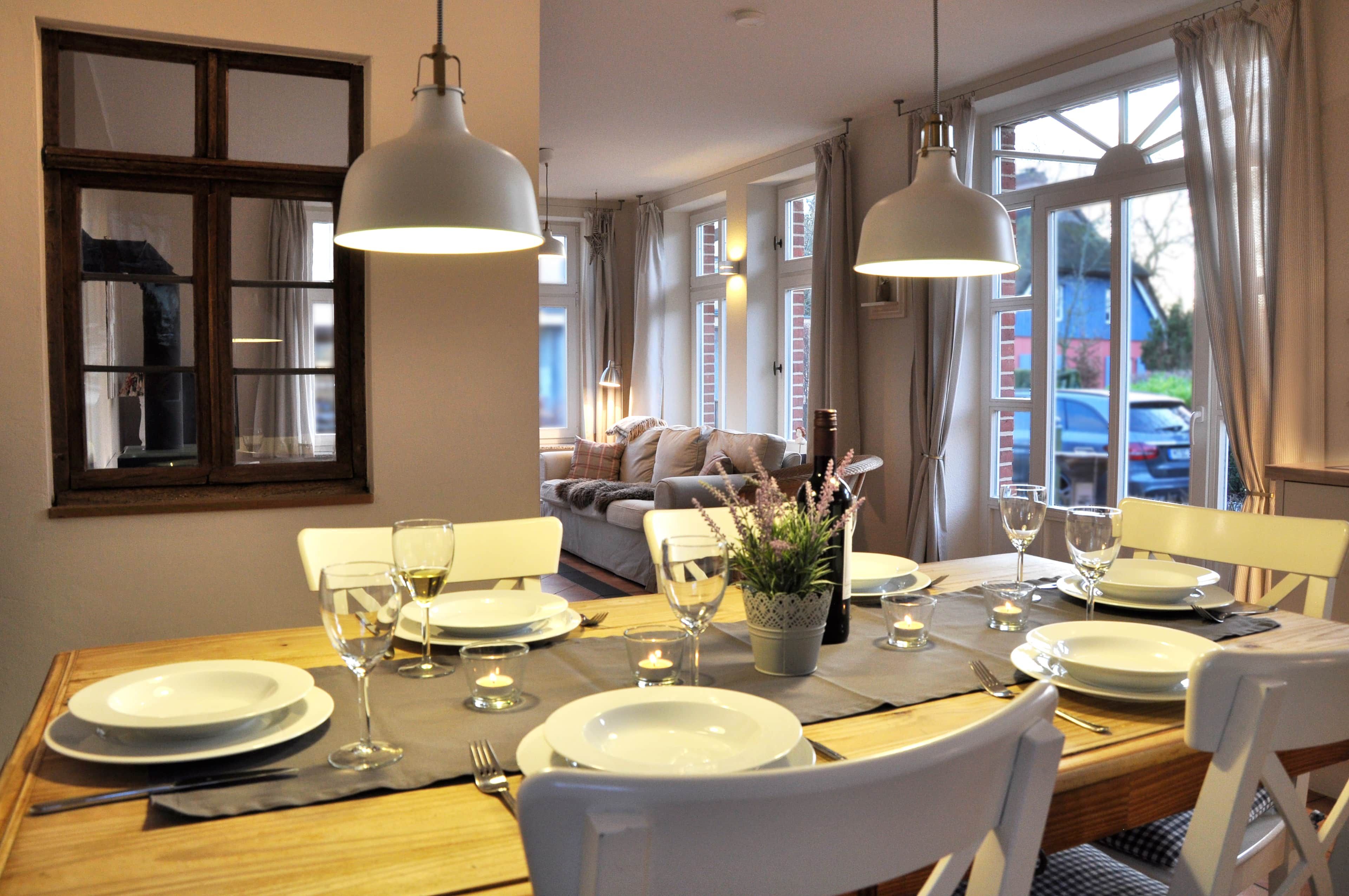 A dining area with a table set for four, including plates, glasses, and cutlery.