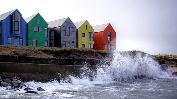 A row of colorful houses by the sea.